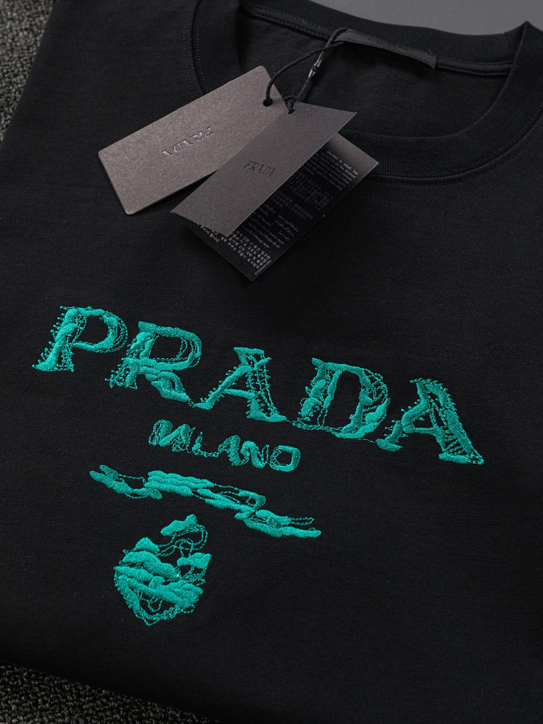 PRADA 25SS Oversized Embroidered Logo T-Shirt with Metal Triangle Badge | S–XL